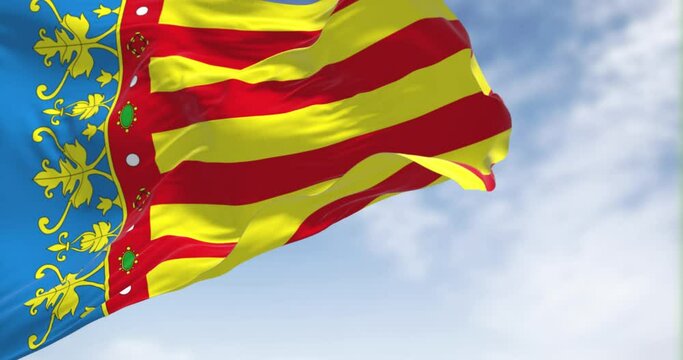 The Valencian Community flag waving in the wind on a clear day