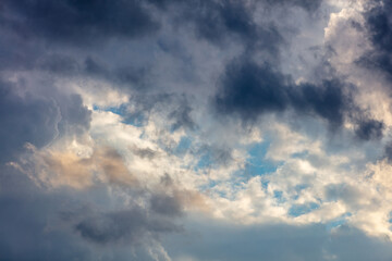 Fototapeta na wymiar Cloud on blue sky background. Cloudscape grey and orange shade. Twilight light color the cloudy sky