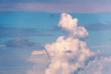 Obraz premium White and blue cloudy background. A large cumulus cloud at sunset. Clouds in the sky.