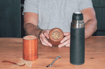 Mate with yerba, steps to prepare mate, traditional Argentine drink.