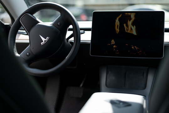 steering wheel and screen in the interior of the tesla electric car