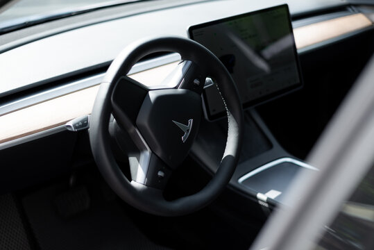 steering wheel and screen in the interior of the tesla electric car