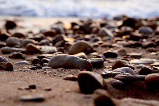 foamy waves and smooth wet pebbles
