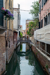 Narrow canal in the city of Venice on a summer day