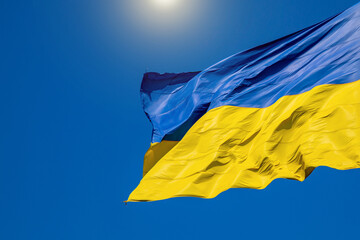 Flag of Ukraine on a background of blue sky. The largest flag in Ukraine.