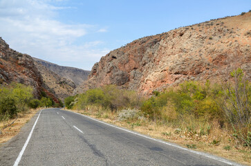 Asphalted track among the mountain gorge of the Caucasus mountains in Armenia. Travel and transport concept