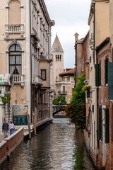 Fototapeta na wymiar Narrow canal in the city of Venice on a summer day