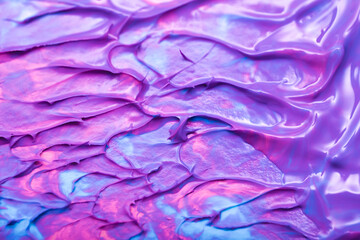 Beautiful abstract background with spots of blue, pink, green, yellow and purple paint. Oil paint, flowing down the canvas, shimmers with galagrophic paints with neon illumination.