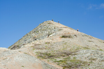 Fototapeta premium Pico Pilon de Azucar, people climbing the mountain. Colombian La Guajira desert. Landscape in the desert.