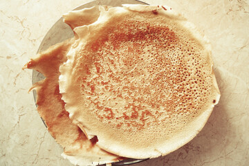 fried pancakes are on a plate, strawberry jam is on top