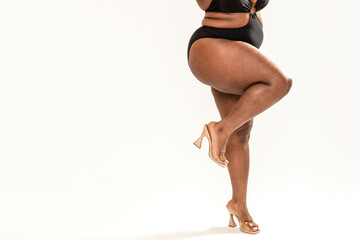 Real body of plus size African woman. Concept of body acceptance, body positivity. Legs with...