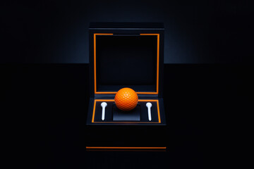 Black box with orange golf ball and white golf tees.