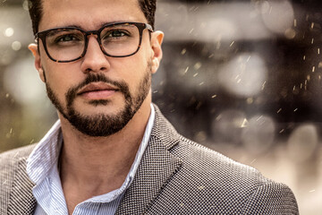 Portrait of handsome man with beard wearing eyeglasses and looking at the camera. Elegant style.