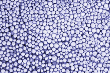 Beautiful background with mother-of-pearl pearls, top view.Violet and silver colors. Demonstrating...