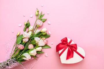 Valentine's Day. Love background. Gifts in the form of hearts on a pink background with the inscription love flower bouquet. Copy space for text. The concept of romance and love. March 8 women's Day.