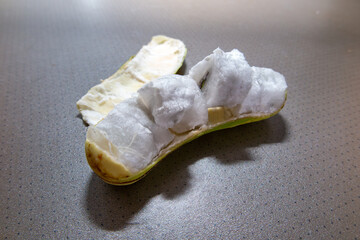 Open Ingá fruit, ingazeiro, Brazilian fruit very common throughout the country, succulent and sweet. Ripe fruits isolated on the table in closeup