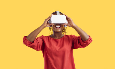 Smiling young African American woman in VR glasses feel excited exploring new horizons. Happy girl in virtual reality headset watch technological images in modern gadget. Technology concept.