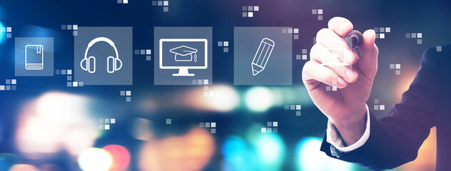 E-learning concept with businessman on night city background