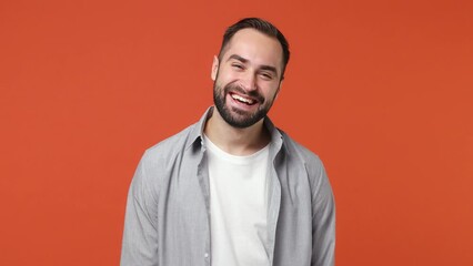 Blithesome charismatic playful happy swanky young brunet man 20s years old wears blue shirt close eyes with hands play guess who or hide and seek isolated on plain orange background studio portrait