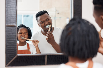 Make sure you get every tooth. Shot of a young father bonding with his daughter while they brush their teeth in the bathroom at home. - obrazy, fototapety, plakaty