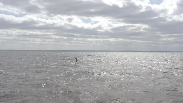 Ukraine. Kyiv. Athletes ride kite surfin. Kiev sea. Summer. Windy weather. Competition. Colored sails. Aerial.
