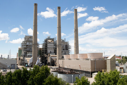 A Power Plant With Several Smoke Stacks in the Daytime