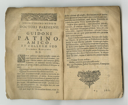 Weathered latin book. An old book with its pages on display.