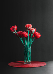  Tulips in a vase on black background.
Bouquet of tulips in a vase on a black background. 
Floral concept and background. 