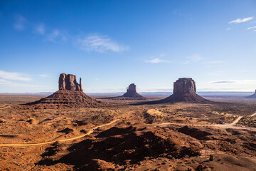 Fototapeta na wymiar Classic southwest desert landscape under a blue sky and bright sun in Monument Valley in Arizona and Utah.