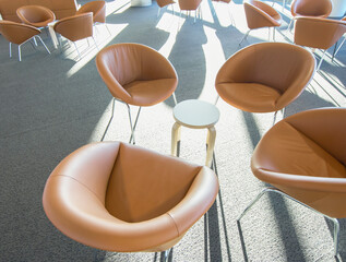Tan leather chairs and tables in public waiting area