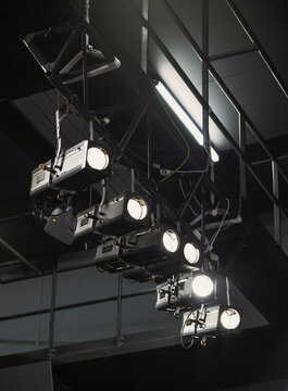 Row of spotlights overhead in theatre