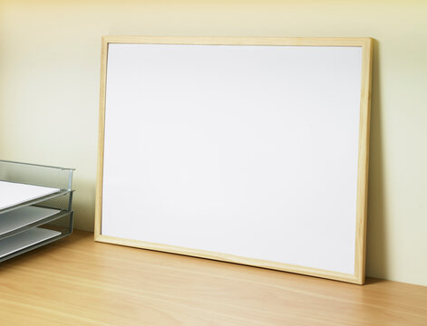 Close up of blank whiteboard resting on desk