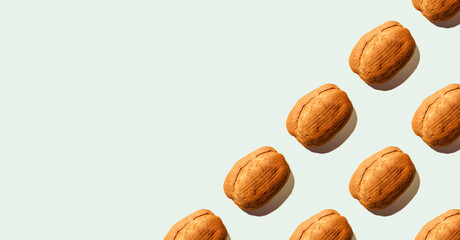 Composition from bread with shadows on blue pastel soft color background. Sourdough bread. Eco-friendly products. Still life. Food concept. Copy space. Space for text. Banner