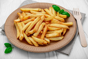 French fries. Fried potatoes on a paper plate.