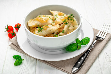 Boiled dumplings on a white plate close-up. Vareniki.