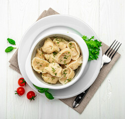 Plate with delicious handmade dumplings on white background