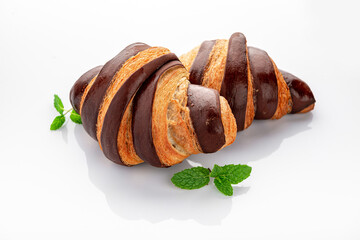 Fresh croissant with chocolate on a white background.