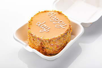 Bento cake with inscription, Happy day, in plastic box-packaging. Carrot cake