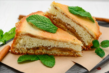 Sponge cake with apples on a white background.