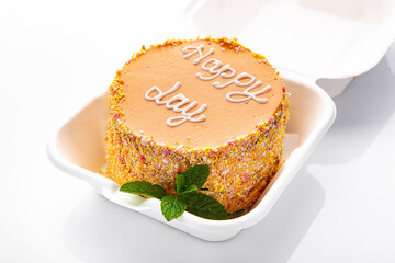 Bento cake with inscription, Happy day, in plastic box-packaging. Carrot cake