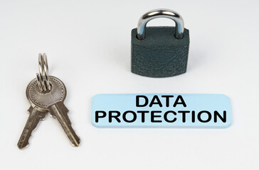 On a white surface there is a lock, keys and a blue sign with the inscription - Data protection