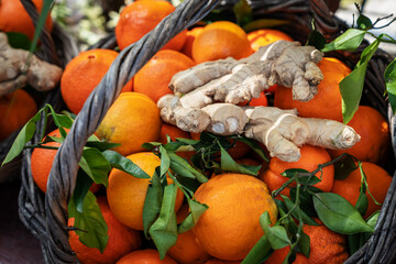 Freshly oranges and ginger root in Wicker basket. Healthy food, healthy lifestyle concept.