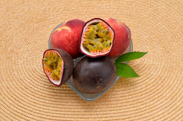 appetizing fresh fruits, passion fruit and peaches in a vase on the table