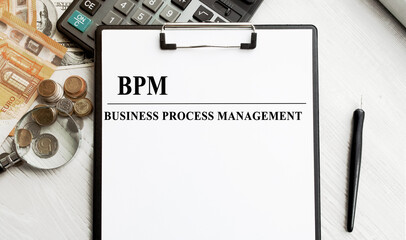 Notepad with an inscription on a business or financial theme. Conceptual image, business accessories, calculator isolated on the desktop. Finance or business concept.