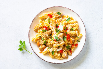 Italian food. Pasta with turkey or chicken, vegetables and parmesan. Top view with copy space at white.
