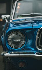 Classic Ford Mustang convertible in blue, parked in the city. Ford mustang is one of the most...
