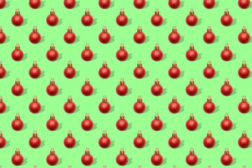 Christmas New Year holiday creative minimal seamless pattern green background with red baubles balls decorations, ornaments, Flat lay, top view