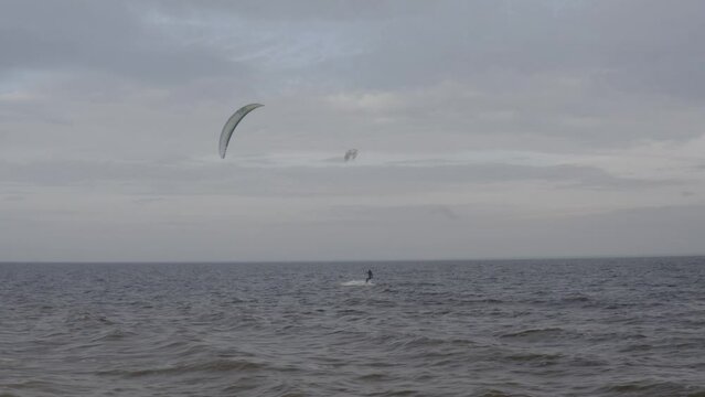 Athletes ride kite surfin. Kiev sea. Summer. Windy weather. Competition. Colored sails. Aerial. Ukraine. Kyiv. 