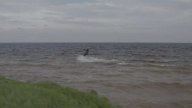 Athletes ride kite surfin. Kiev sea. Summer. Windy weather. Competition. Colored sails. Aerial. Ukraine. Kyiv. 