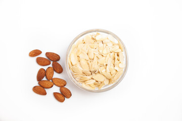 Almonds nuts with petals as ingredient for confectionery close up on white backgrounds 